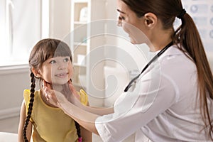 Doctor examining adorable child in hospital