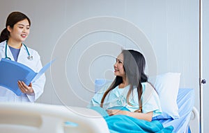 Doctor examining asian woman patient and follow up treatment at hospital