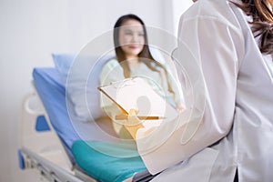 Doctor examining asian woman patient and follow up treatment at hospital