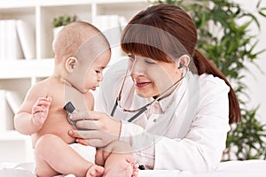 The doctor examining baby with stethoscope