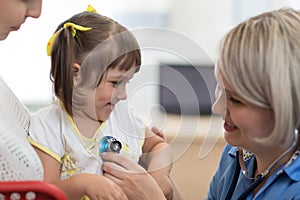 Doctor examining baby with stethoscope in clinic. Baby health concept