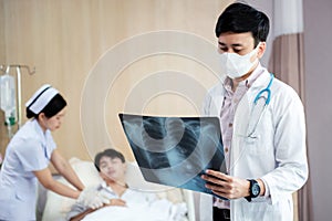 Doctor examining at chest and lung x ray film of patient