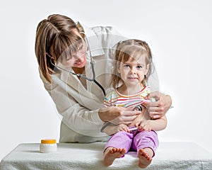 Doctor examining child girl photo