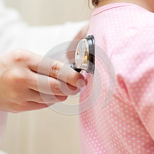 Doctor examining a child girl in a hospital