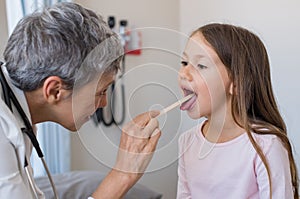 Doctor examining child mouth