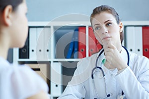 Doctor examining a child patient teeth by orthodontic tools.