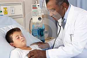 Doctor Examining Child Patient On Ward