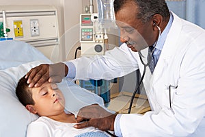 Doctor Examining Child Patient On Ward