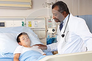 Doctor Examining Child Patient On Ward