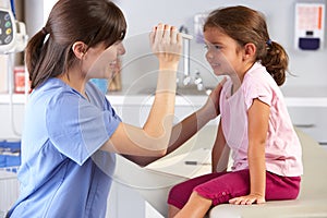 Doctor Examining Child's Eyes In Doctor's Office