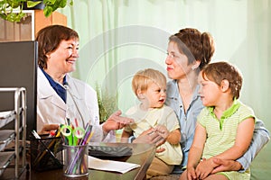 Doctor examining children