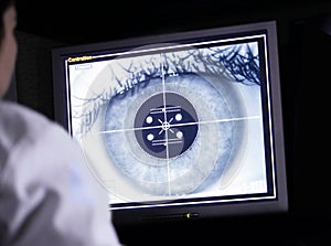 Doctor examining eye scan on computer