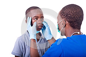 Doctor examining the eyes of a little boy