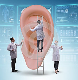 Doctor examining giant ear in medical concept