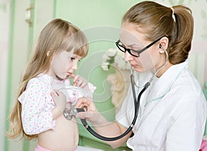 Doctor examining girl with stethoscope
