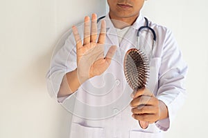 Examining the hair brush to prove hair loss. photo