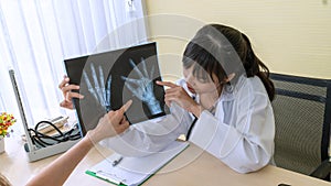 A doctor examining the hand and arm x-ray film Including the body at the hospital