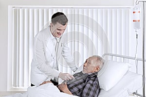 Doctor examining heartbeats on hospitalised patient