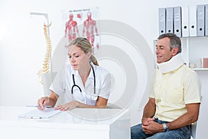 Doctor examining her patient wearing neck brace