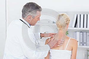 Doctor examining his patient back