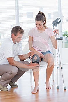 Doctor examining his patient knee