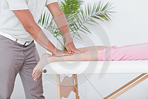 Doctor examining his patient leg