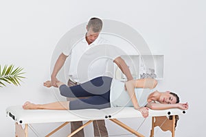 Doctor examining his patient leg