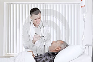 Doctor examining his patient in the recovery room