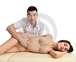 Doctor examining his patient stomach or making abdomen massage isolated on white