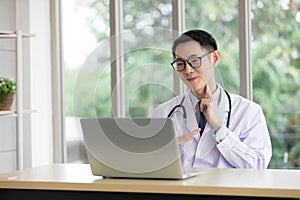 Doctor examining hold a hand near his neck, finger pressures for showing patient through online video chat with computer in