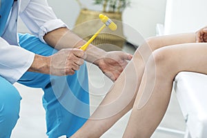 Doctor examining the knee reflex photo