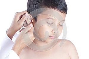 Doctor examining little boy`s ears.