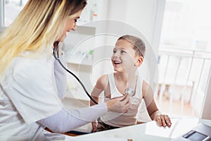 Doctor examining a little boy by stethoscope