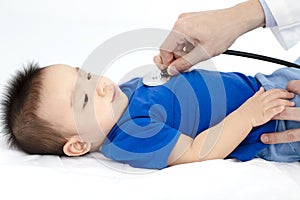 Doctor examining little boy by stethoscope