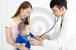 Doctor examining little boy by stethoscope