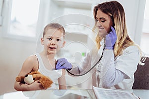 Doctor examining a little boyl by stethoscope