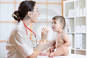 Doctor examining little girl baby