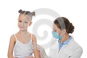 Doctor examining little girl with chickenpox on background. Varicella zoster virus