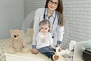 Doctor examining a little girl in a hospital.