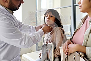 Doctor examining little girl in hospital