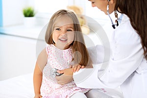 Doctor examining a little girl by stethoscope