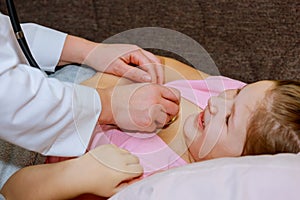 Doctor examining little girl with stethoscope the hospital healthcare and medicine