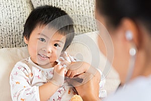 Doctor examining a little girl by using stethoscope.