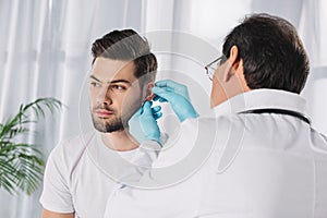 doctor examining male patient