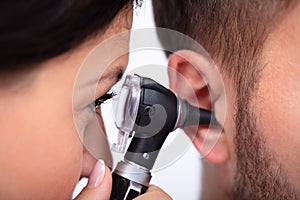 Doctor Examining Male Patient`s Ear