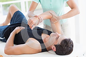 Doctor examining man arm