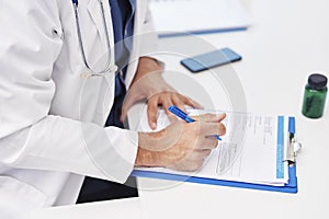 Doctor examining the medical record on the clipboard