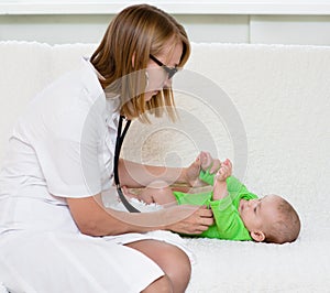 Doctor examining newborn baby with stethoscope
