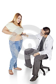 Doctor examining obese woman belly