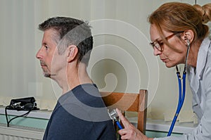 Doctor examining a patient at an appointment.